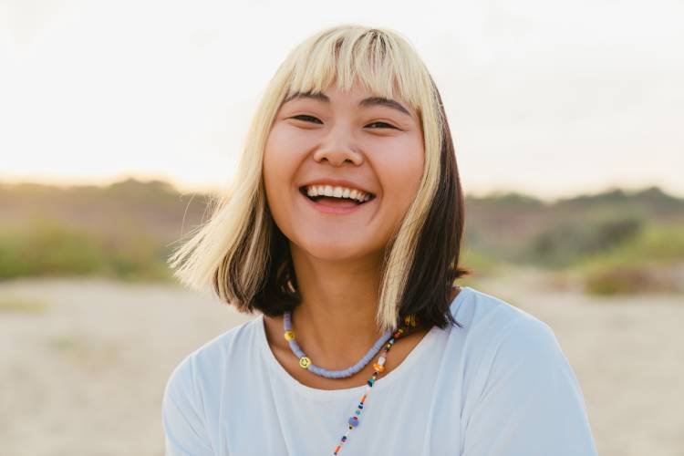 young-asian-woman-laughing-while-walking-on-beach-2025-02-16-03-59-50-utc.jpg